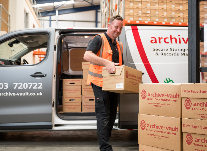 warehouse employee unloading document storage boxes