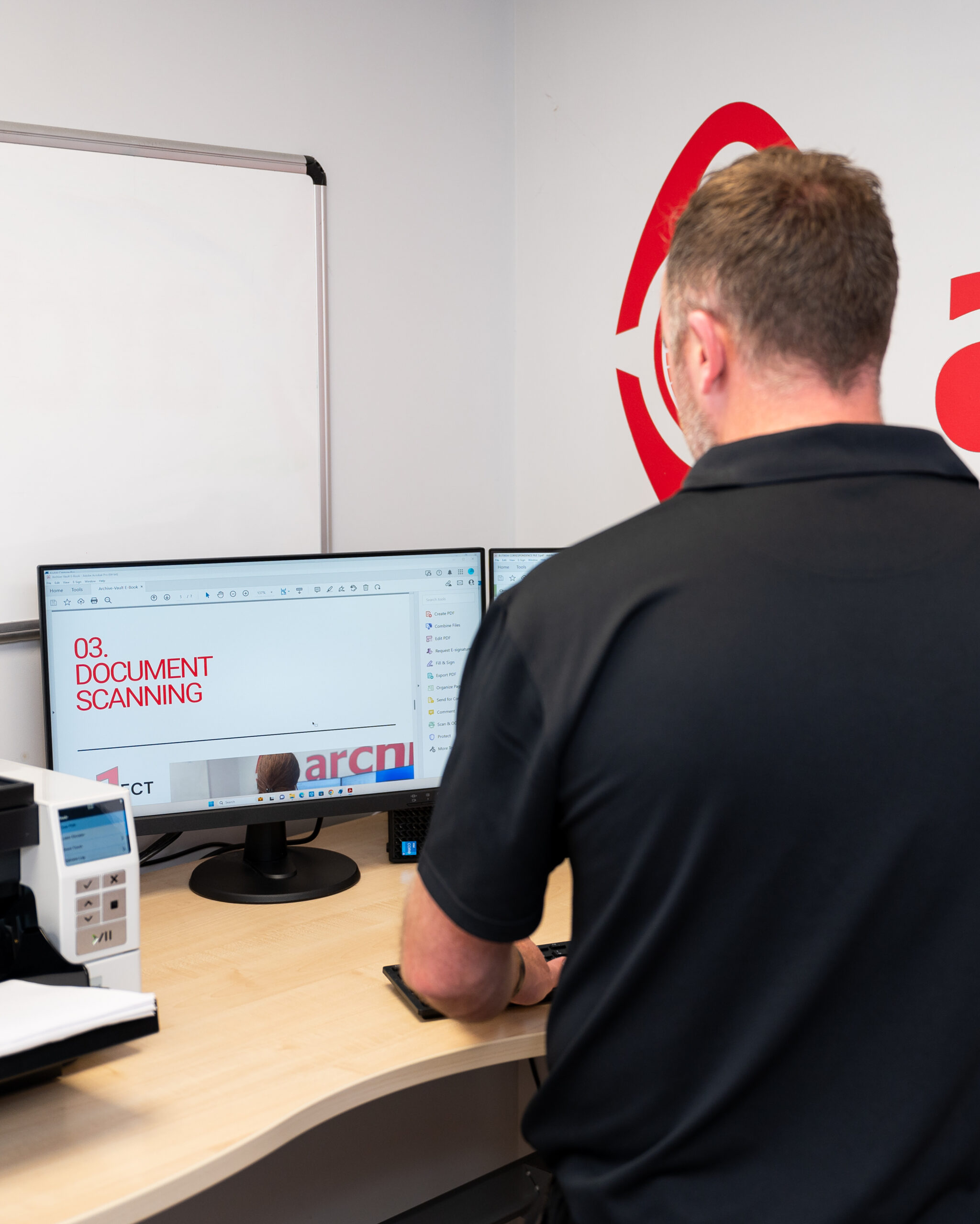 employee looking at scanned documents on computer