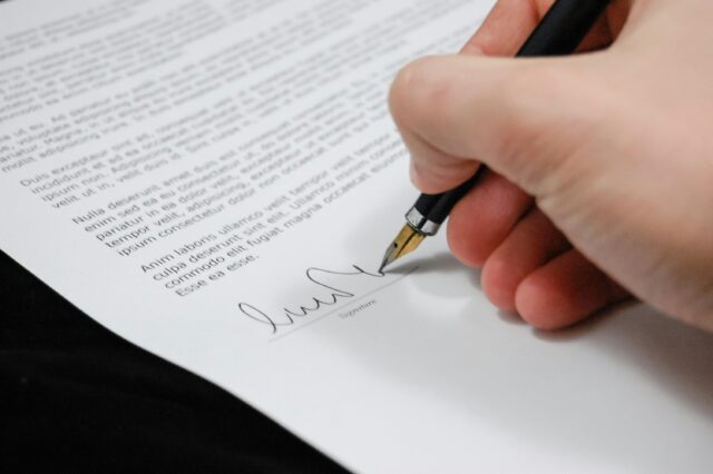 person signing important document