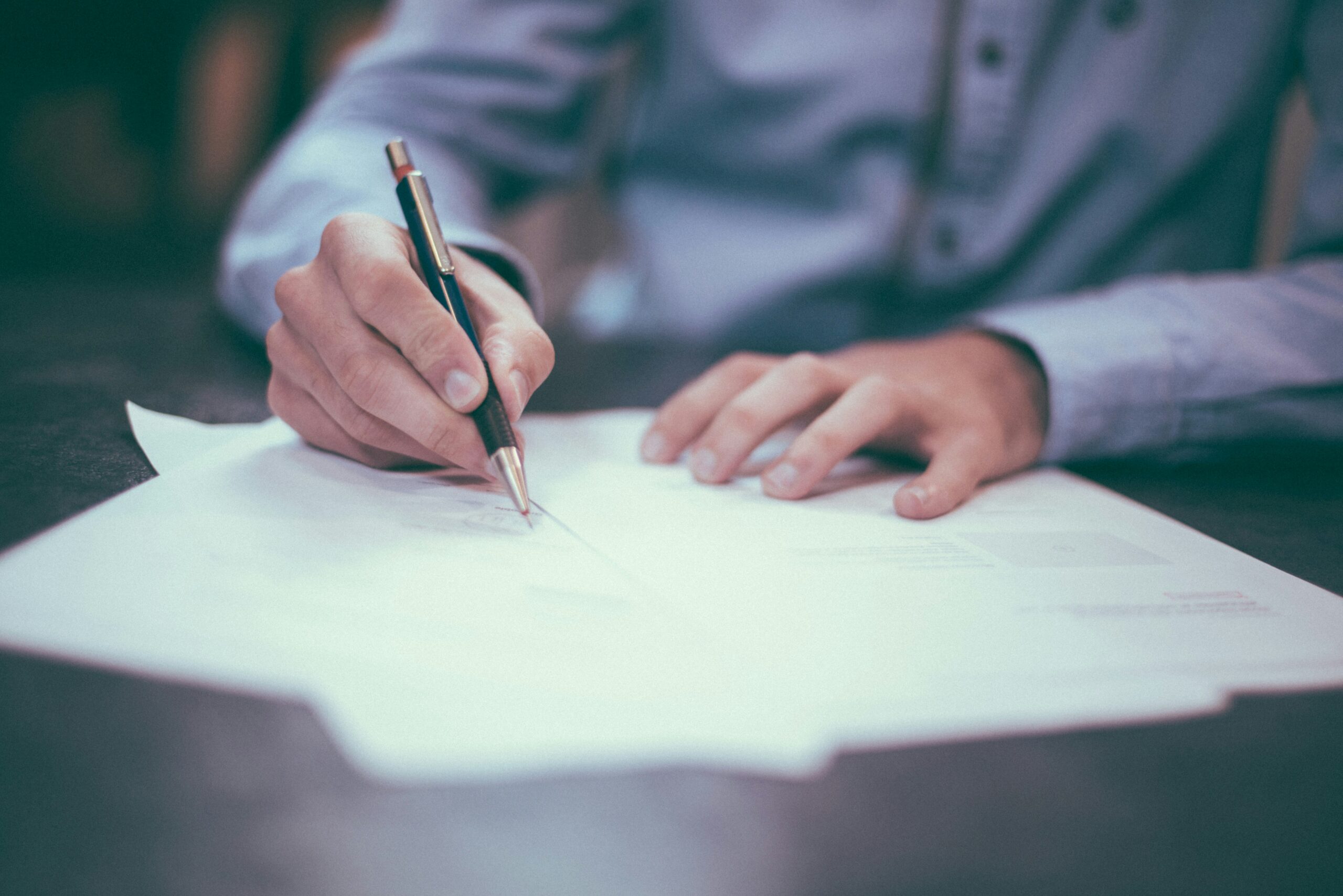 businessman signing financial documents